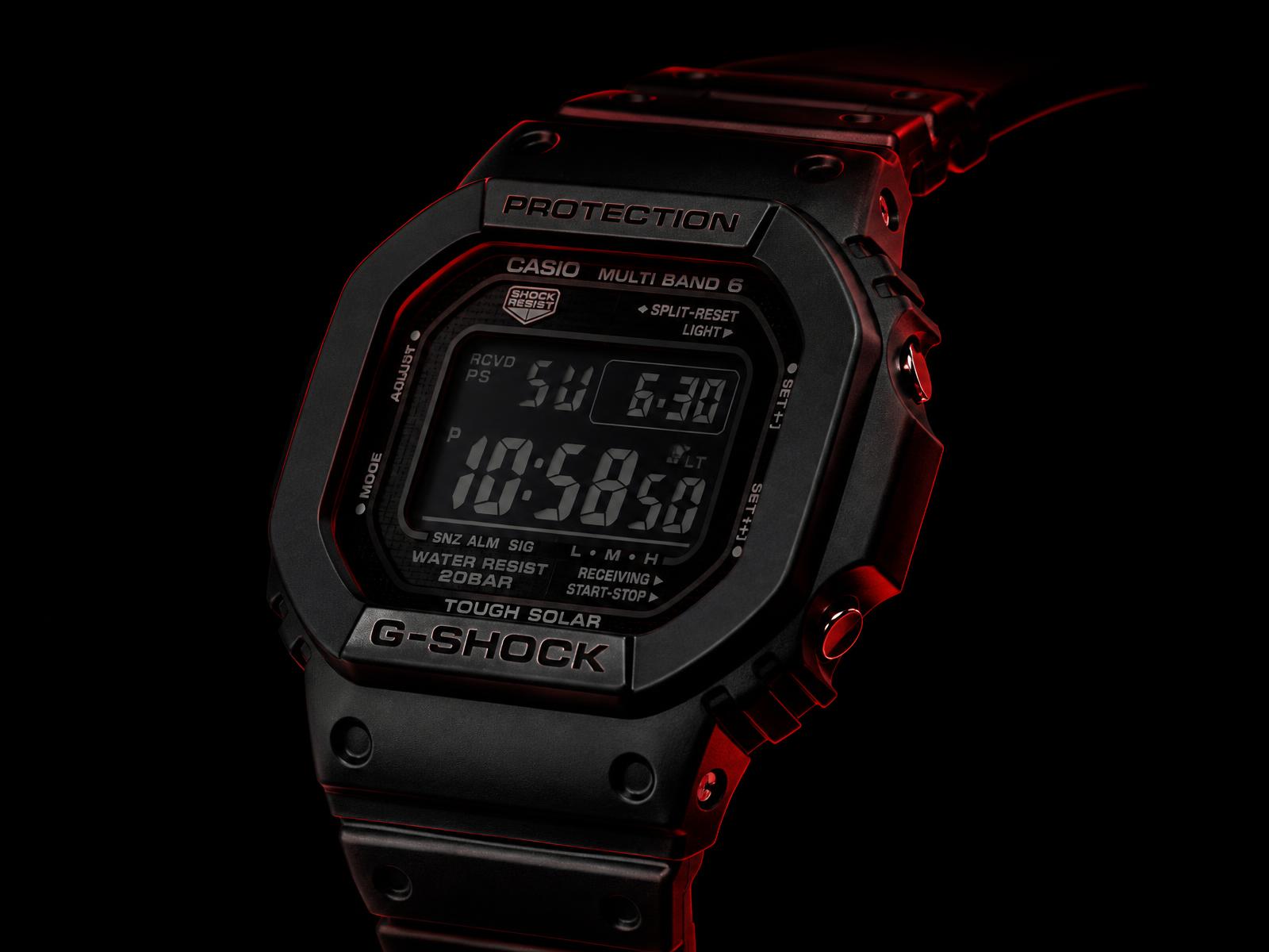 Blacked-out G-Shock watch lit with red rim light